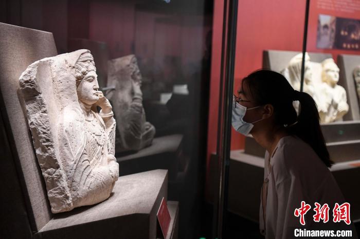 觀眾參觀石灰?guī)r高浮雕婦女墓碑雕像。　楊華峰 攝