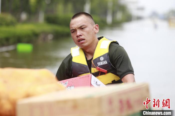 圖為賀樂在抗洪一線搬運(yùn)救災(zāi)物資?！』魜喥?攝