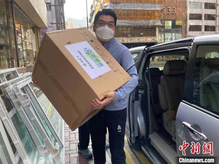 圖為吳學(xué)明搬運(yùn)1200份快速檢測套裝及500多個口罩，捐贈給開平樓崗?fù)l(xiāng)會?！∈茉L者供圖