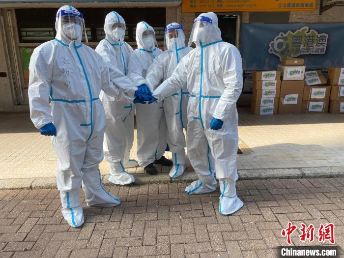 圖為吳學(xué)明(右一)等人穿著防護(hù)服來到前線協(xié)助全港抗疫?！∈茉L者供圖