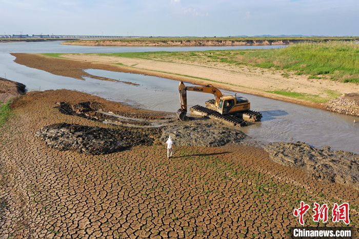 圖為8月23日，在鄱陽(yáng)湖畔的江西省南昌市進(jìn)賢縣三里鄉(xiāng)六零圩，施工負(fù)責(zé)人正在指揮挖渠蓄水的挖掘機(jī)操控人員。（無(wú)人機(jī)照片） <a target='_blank' href='/'>中新社</a>記者 劉占昆 攝