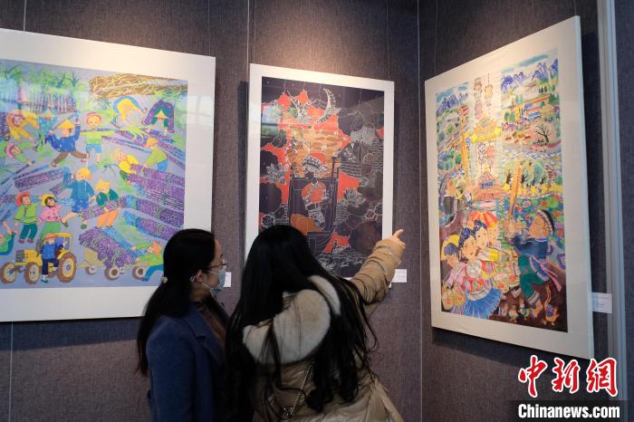 圖為前來觀展的民眾正在交流作品?！⒖÷?攝