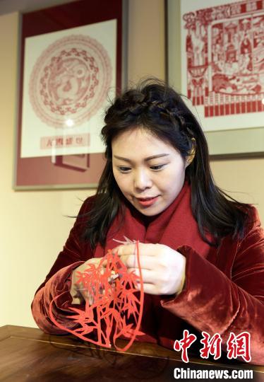 圖為梁巧艷在剪窗花?！⊥鯆赡?攝