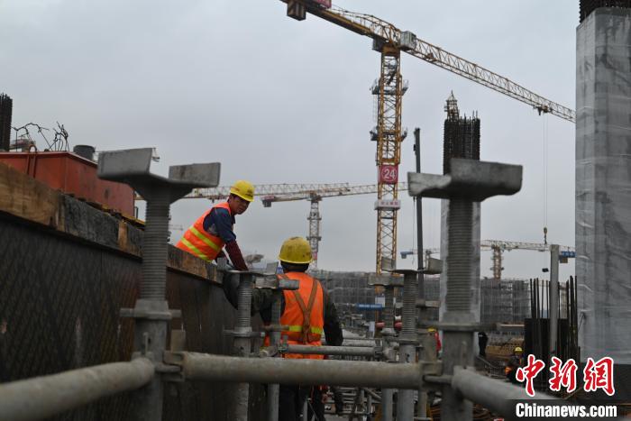 圖為置身鋼筋混凝土之間的工人。　張旭 攝