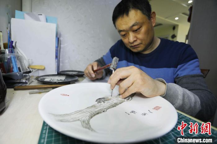 今年48歲的黃海濤，是一名聽(tīng)障人士，現(xiàn)任泰安市特殊教育中心的美術(shù)教師。　陳陽(yáng) 攝