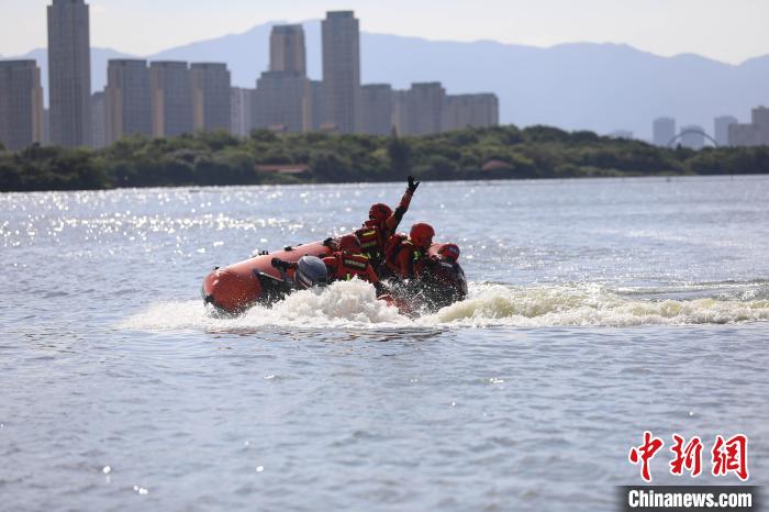 在離心力的作用下消防員一把將“落水者”拉上艇?！±钤x 攝