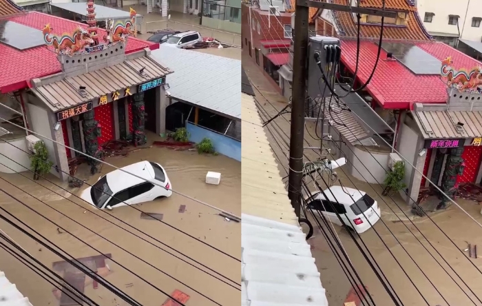 高雄大小區(qū)鹽埕巷于25日被洪水淹沒，街道成汪洋，有民眾的車輛被水沖走